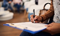 Patient filling out paperwork in lobby