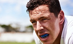 Closeup of man exercising with blue mouthguard