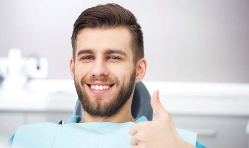 dental patient giving a thumbs up