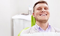 Smiling man sitting in dental office