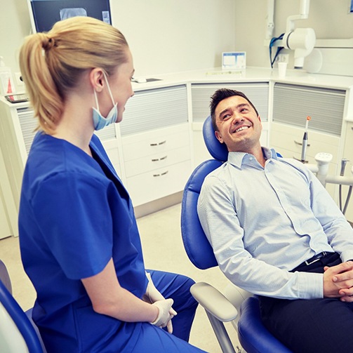 man sitting in dental chair and smiling at dentist in Idaho Falls