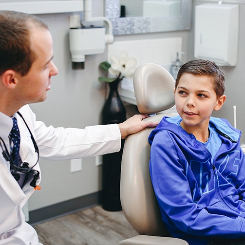 Young boy in dental chair talking to childrens dentist in Idaho Falls