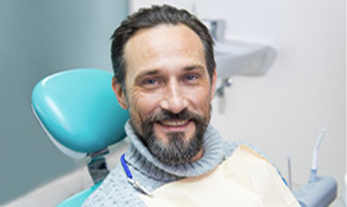 Smiling man sitting in dental chair