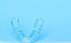 Clear mouthguard against light blue background