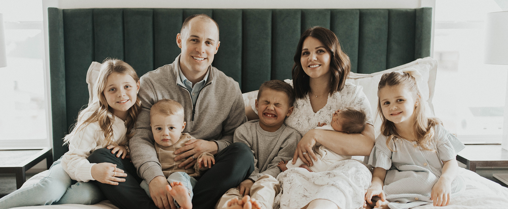 Doctor Cline and his family smiling in forest