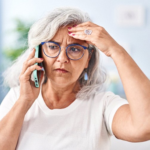 a concerned woman on the phone with an emergency dentist in Idaho Falls