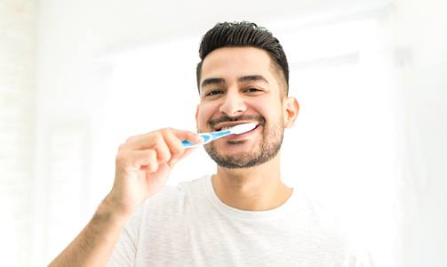 a man brushing his teeth