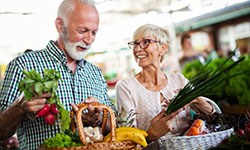 elderly couple buying fresh produce