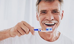 man brushing teeth