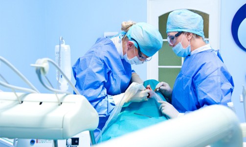 Dentists performing dental implant surgery