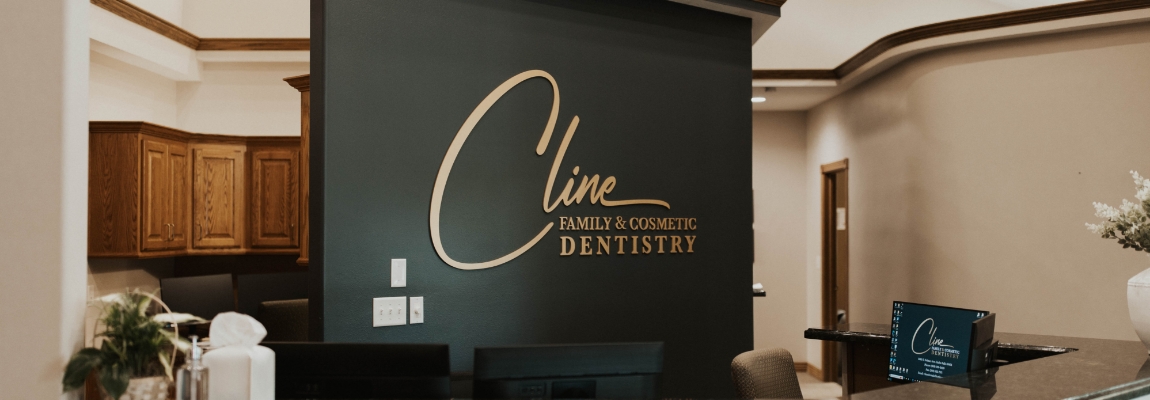 Cline Family and Cosmetic Dentistry logo on dental office wall