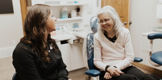 Dental team member at reception desk smiling