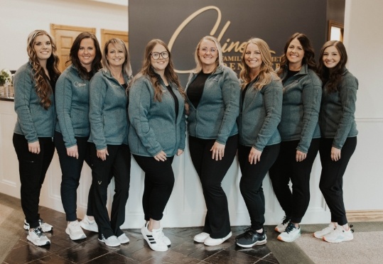 Five smiling members of the Cline Family and Cosmetic Dentistry team