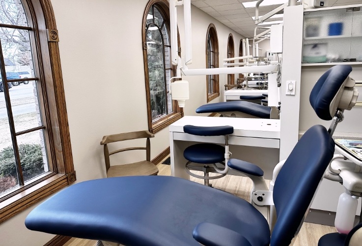 Row of blue leather dental treatment chairs