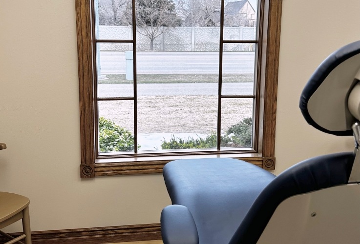 Dental treatment room with large window in front of chair