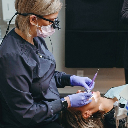 Dental hygienist cleaning teeth during preventive dentistry visit