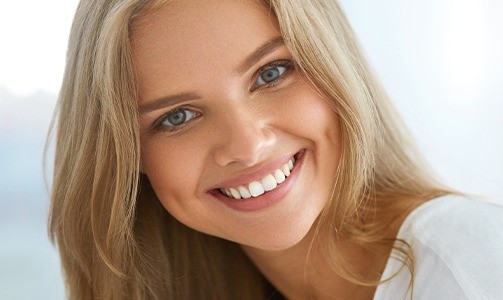 Woman smiling after fluoride treatment