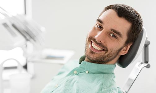 Man in dental chair smiling after root canal