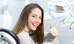 Woman giving thumbs up for sedation dentistry in Idaho Falls