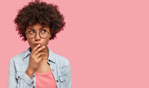 Woman on pink background wondering about sedation dentistry in Idaho Falls