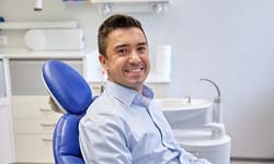 Smiling man sitting in dental chair