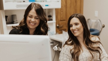 Dental team member smiling with relaxed patient