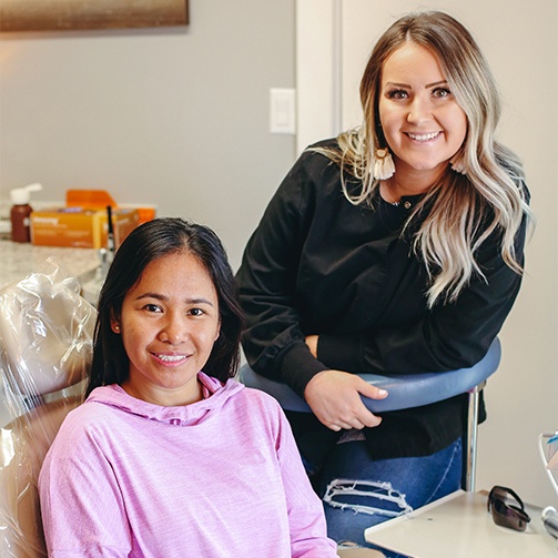 Dental team member and patient smiling at visit for T M J treatment in Idaho Falls