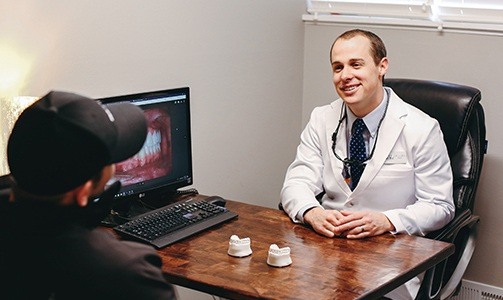 Dentist smiling at patient during veneer consultation