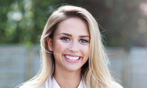 Woman smiling after teeth whitening