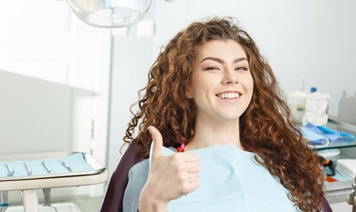 woman in the dental chair giving a thumbs up after professional teeth whitening in Idaho Falls