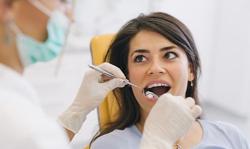 Dentist removing wisdom tooth from a patient