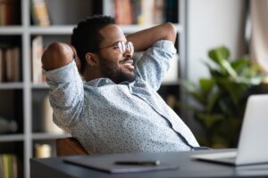 a relaxed person leaning back in a desk chair